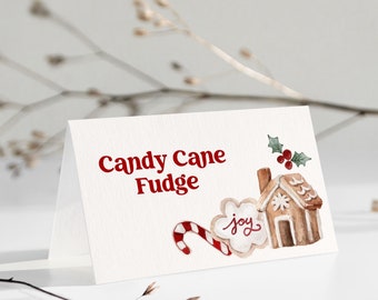 May include: A folded white card with the words "Candy Cane Fudge" in red. The card features watercolor illustrations of a candy cane, gingerbread house, and a cookie with the word "joy".