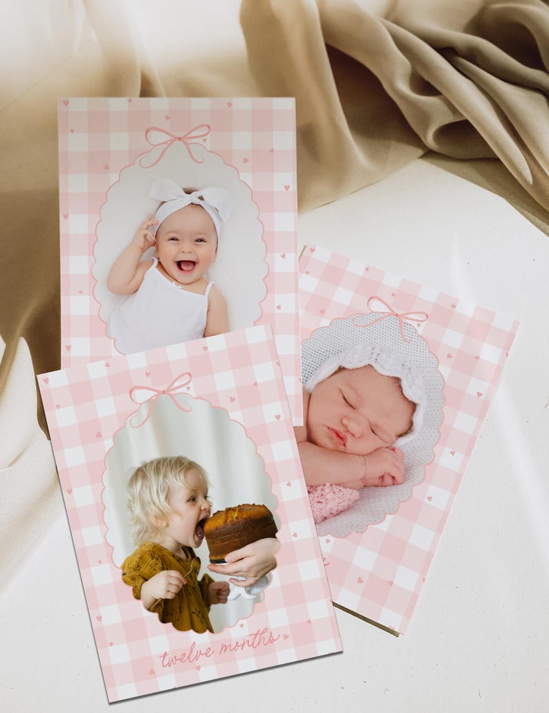 May include: Three pink and white gingham baby photo cards with oval frames and bow accents. Each card features a different baby photo. One card has the text "twelve months".