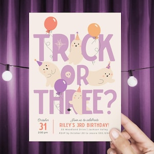 May include: A Halloween party invitation with the words "Trick or Three?" in purple. The design includes cartoon ghosts, balloons, and a spider. The invitation is for Riley's 3rd birthday on October 31st.
