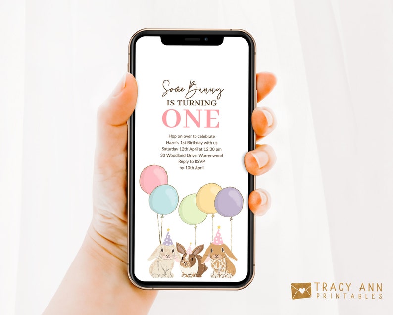 May include: A digital invitation for a first birthday party with a bunny theme. The invitation features a pink, yellow, and blue balloon bouquet, two bunnies wearing party hats, and the text "Some Bunny is Turning One". The invitation also includes the date, time, and location of the party.