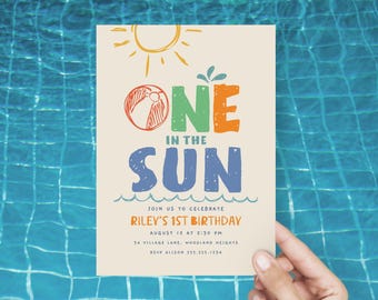 May include: A colorful invitation for a first birthday party with the text "One in the Sun" and a beach ball graphic. The invitation includes the date, time, and location of the party.