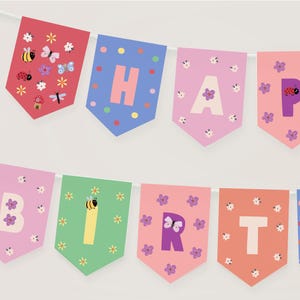 May include: A vibrant banner spelling "HAPPY BIRTHDAY" with individual pennants. Each pennant is a different colour, featuring letters, flowers, insects, and polka dots. The banner is strung on a white string, ideal for a birthday celebration.