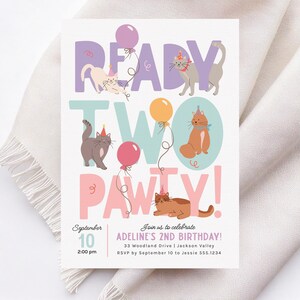 May include: A colorful invitation for a second birthday party with a cat theme. The invitation features the words "Ready Two Pawty!" with illustrations of cats wearing party hats and balloons. The text on the invitation says "September 10, 2:00 pm, Join us to celebrate Adeline's 2nd Birthday! 33 Woodland Drive | Jackson Valley RSVP by September 10 to Jessie 555.1234"