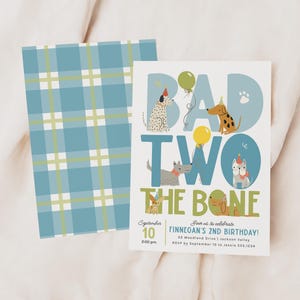 May include: A birthday invitation with a blue plaid pattern on the back. The front features the words "BAD TWO THE BONE" with dog illustrations and balloons. The invitation includes the date, time, and location of the birthday party.