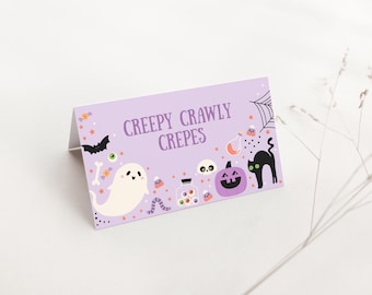 May include: A lavender Halloween-themed card with the text "Creepy Crawly Crepes." The card features illustrations of a ghost, bat, black cat, jack-o'-lantern, and other spooky elements. Perfect for Halloween parties or events.