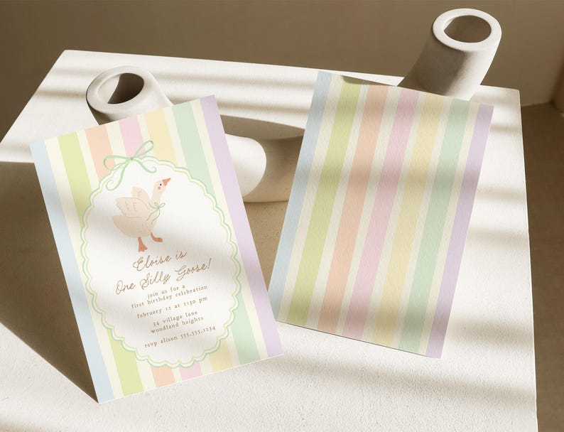 May include: A pastel striped invitation card with a cute illustration of a goose. The text on the card reads "Elise is One Silly Goose!" and includes details for a first birthday celebration.