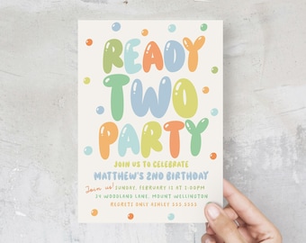 May include: A colourful invitation for a birthday party with the text "Ready Two Party" in bubble letters. The invitation is for Matthew's 2nd birthday and includes the date, time, and location of the party. It also includes the text "Join us!" and "Regrets only Ashley 555.5555".