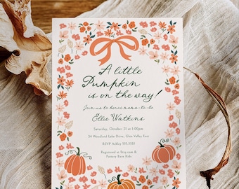 May include: A baby shower invitation with a floral and pumpkin design. The invitation features the text "A little Pumpkin is on the way!" and details for the event. The design includes a peach bow, orange pumpkins, and peach and orange flowers.
