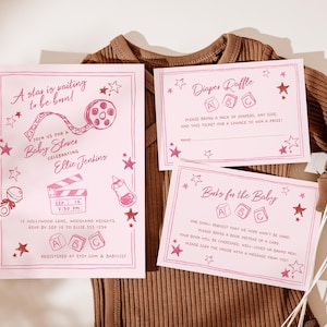 May include: Pink baby shower invitations and inserts with star and film reel illustrations. The invitation reads "A star is waiting to be born!" and includes event details. Inserts include a diaper raffle and a request for books for the baby.