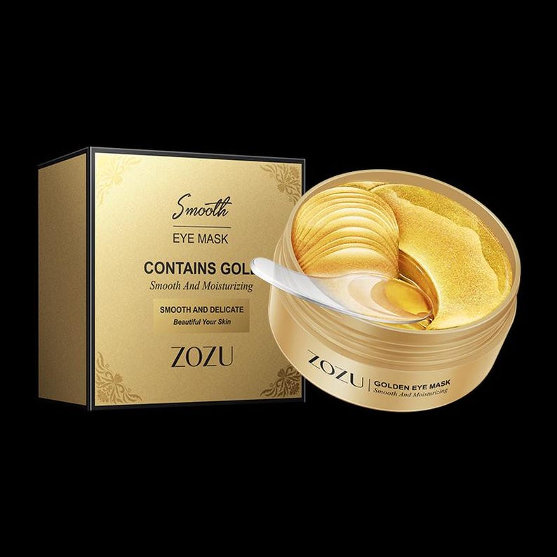 May include: Gold eye mask in a jar with a gold lid and a gold spatula. The jar has the text "ZOZUI GOLDEN EYE MASK Smooth And Moisturizing" on the front. The box has the text "Smooth EYE MASK CONTAINS GOLD Smooth And Moisturizing SMOOTH AND DELICATE Beautiful Your Skin ZOZU" on the front.