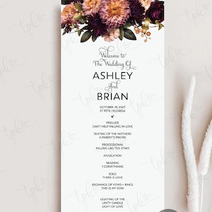 May include: A vertical wedding program card featuring a floral arrangement of dark purple, pink, and orange flowers at the top. The text reads: Welcome to The Wedding Of ASHLEY And BRIAN, OCTOBER 18, 2027, ST PETE | FLORIDA, and a full ceremony order.