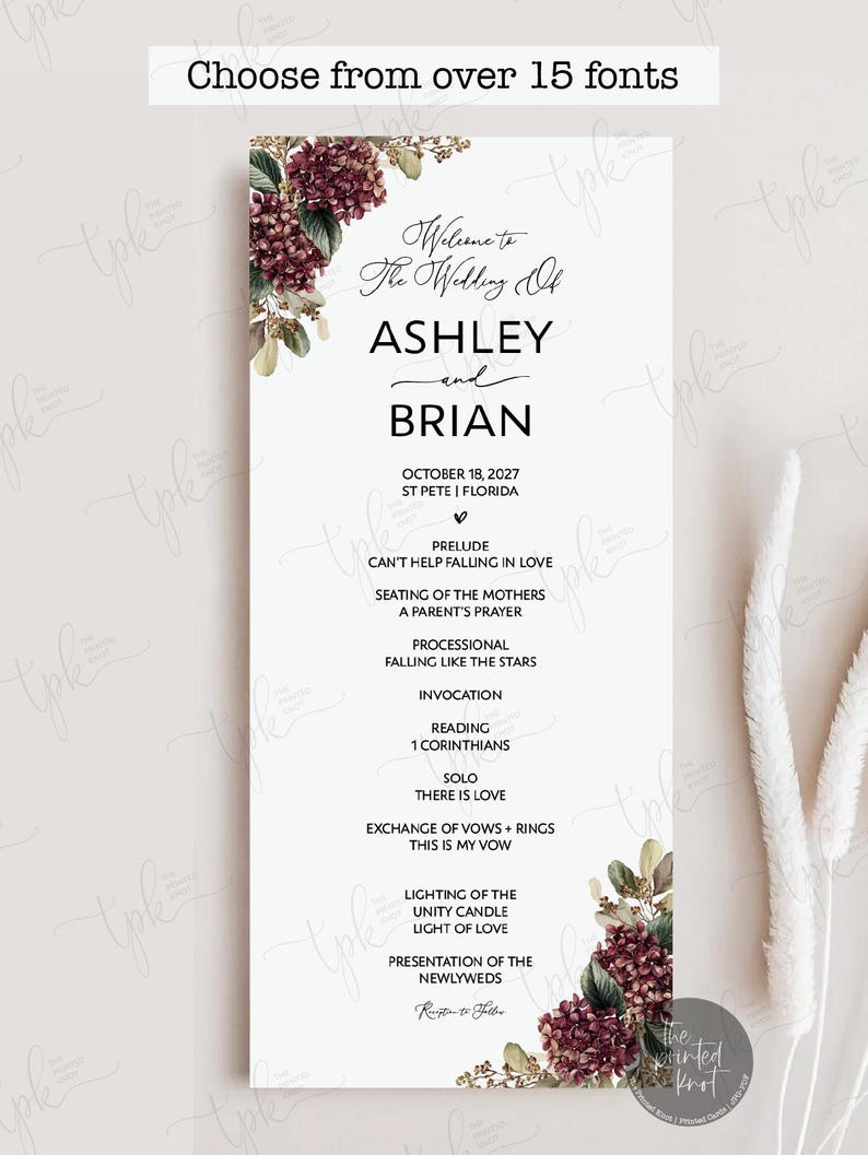 May include: A vertical wedding program card featuring dark burgundy hydrangea floral accents at the top left and bottom right corners. The text reads: Welcome to The Wedding Of ASHLEY and BRIAN, October 18, 2027, St Pete, Florida, and a full ceremony order.