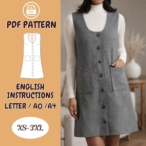May include: A grey button-down pinafore dress with two front pockets. The dress is worn over a white roll-neck top. The image also shows a PDF pattern with the text "PDF PATTERN", "ENGLISH INSTRUCTIONS", and "XS-3XL".