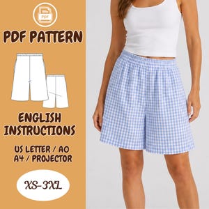 May include: A PDF sewing pattern for elastic-waist shorts in sizes XS-3XL. The digital file includes English instructions compatible with US Letter, A0, A4, and projector formats. The shorts feature a light blue and white gingham check pattern.