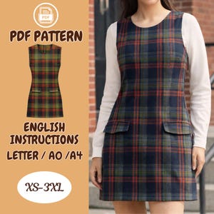 May include: A plaid jumper dress in navy, red, and green, with two front pockets. The dress is sleeveless and worn over a white long-sleeved shirt. The image includes text that says "PDF Pattern", "English Instructions", and "XS-3XL".