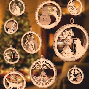 May include: A collection of wooden Christmas ornaments with various holiday-themed designs. Each ornament is circular with a cutout design, including a snowman, cat with a gift, and a nativity scene. The ornaments are made of light-colored wood and have a small loop for hanging.
