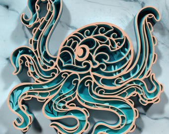 May include: A layered wooden octopus sculpture in shades of teal and natural wood. The octopus design features intricate cut-out details and a three-dimensional effect. The artwork is displayed against a marbled background, enhancing the visual appeal.
