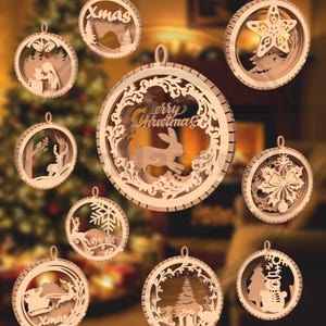 May include: A collection of wooden Christmas ornaments with various designs. Each ornament is circular with a cutout design, including a star, a snowflake, a reindeer, and a snowman. Some ornaments have the word "Xmas" or "Merry Christmas" cut into the wood.