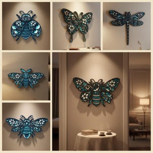 Puede incluir: Colección de arte mural de madera en capas con varios insectos, incluyendo una abeja, una mariposa y una libélula. Las piezas de arte son principalmente de color verde azulado y negro, con detalles florales blancos. Los insectos están montados en una pared neutra.