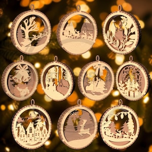 May include: A collection of wooden Christmas ornaments with various winter-themed cut-out designs. Each ornament is circular with a detailed scene, including a reindeer, houses, and trees. The ornaments are made of light brown wood.