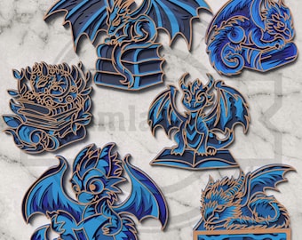May include: A collection of layered wood dragon designs in various poses and styles. The dragons are primarily blue with brown accents, some perched on books. The designs feature intricate details and are suitable for crafting or decor.
