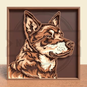 May include: A layered wooden art piece featuring a dog's profile in shades of brown and tan. The artwork is framed in a brown wooden frame, with the dog's head and face in detailed relief against a dark brown background. The dog's fur is intricately carved.