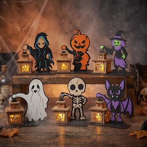 Op de afbeelding: Een set van zes houten Halloween-decoraties met een geest, skelet, vleermuis, pompoen, heks en een figuur met capuchon, elk met een kleine vierkante lantaarn met warm geel licht. De figuren zijn geschilderd in zwart, oranje, paars en wit.