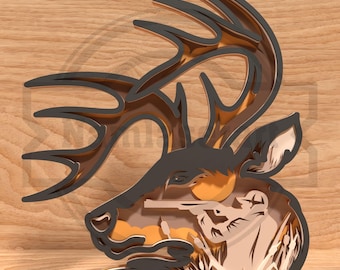 May include: A layered wooden art piece depicting a deer head profile with large antlers. The artwork features a hunter aiming a rifle at a sunset scene. The deer and hunter are in shades of brown and black, with a golden sunset background.