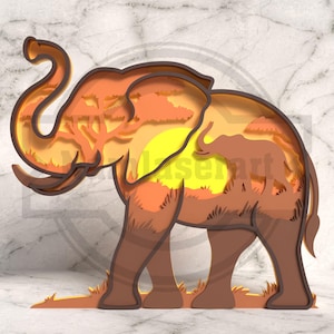 May include: A layered paper art piece depicting an elephant in shades of brown, orange, and yellow. The interior layers show a savanna scene with trees and a setting sun. The elephant is standing on a grassy base.