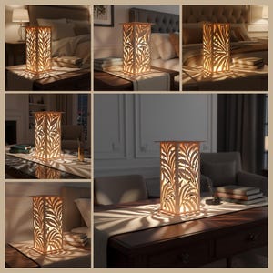 May include: A rectangular wooden lamp with a leaf pattern cut into the sides. The lamp is lit from within, casting leaf-shaped shadows. The lamp is shown in various settings, including a bedroom and a living room.