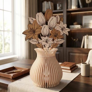 May include: A wooden vase with a light brown finish, featuring a vertical slatted design. The vase holds a bouquet of wooden flowers in shades of brown and beige, including lilies and tulips. The arrangement sits on a table with a neutral-colored runner.