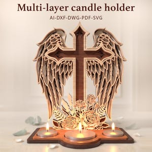 May include: A multi-layer wooden candle holder featuring a central cross flanked by detailed angel wings and floral accents at the base. The design includes three circular cutouts for tea light candles. Text reads: Multi-layer candle holder AI-DXF-DWG-PDF-SVG.