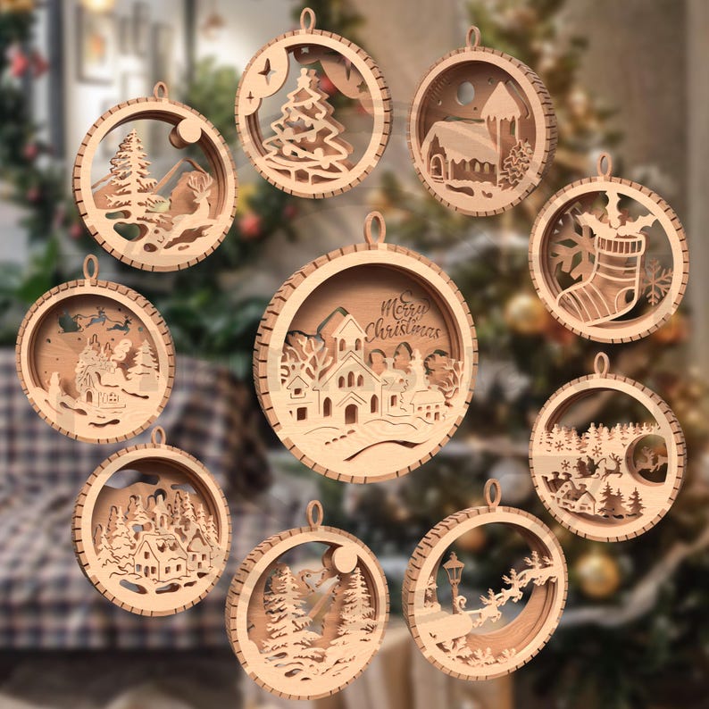May include: A collection of nine wooden Christmas ornaments with various winter scenes. Each ornament is circular, with a detailed cutout design of a landscape, tree, or building. The ornaments are made of light-colored wood and have a loop for hanging.