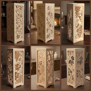 May include: Wooden decorative lamps with intricate grape and vine cutouts. The lamps are rectangular with a light source inside, creating a warm glow. The lamps are displayed on a dark wooden surface.