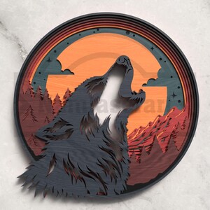May include: A layered wooden artwork showing a howling wolf against a sunset. The design features a dark grey wolf, orange and red mountains, and a circular frame with a dark teal background and stars.
