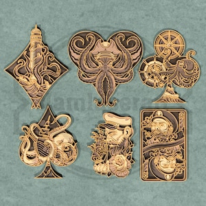 May include: A collection of layered wooden art pieces featuring nautical and sea-themed designs. The designs include a lighthouse, an octopus in a heart shape, a ship's wheel, a skull, a sailor, and a playing card with a sailor. The color palette is primarily brown, beige, and gray.