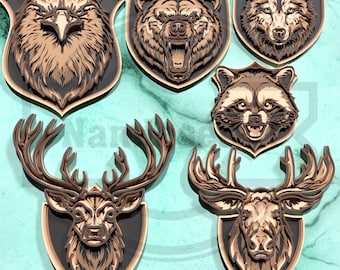 May include: A collection of layered wooden wall art featuring wildlife animal portraits. The set includes an eagle, bear, wolf, raccoon, and two deer or elk, each mounted on a shield-shaped plaque. The art pieces are in shades of brown and black.