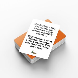 May include: A stack of orange-edged cards with a white card on top. The top card has black text that reads "Sip: Confess a time you accidentally texted the wrong person something awkward. Skip: Perform a short freestyle rap..."