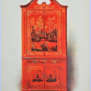 May include: A red cabinet with black and gold painted scenes. The cabinet has two doors on top and two doors on the bottom. The top doors have a scene of people and trees. The bottom doors have a scene of people and trees. The cabinet has gold trim.