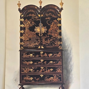 May include: A detailed illustration of a black cabinet with ornate gold accents. The cabinet features a tall, arched top with gold finials and intricate carvings. The drawers and doors are decorated with detailed scenes.
