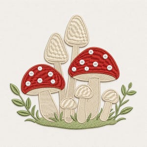 May include: An embroidered patch featuring a cluster of mushrooms with two red caps adorned with white spots and several beige caps. The mushrooms are arranged on a patch of green grass with small green leaves extending from the sides.