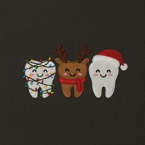 May include: Embroidered patches of three smiling teeth with festive designs. One tooth is wrapped in fairy lights, another is a reindeer with a red scarf, and the third wears a Santa hat. The patches are set against a dark grey background.