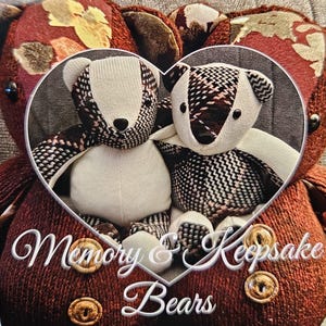 May include: Two teddy bears with white bodies and patterned accents are framed in a heart shape. The bears are set against a backdrop of a larger, textured bear. The image includes the text "Memory & Keepsake Bears".