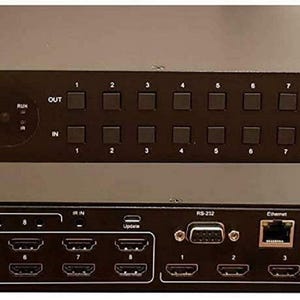Puede incluir: Dispositivo negro 8x8 HDMI Matrix 18gbps con m&uacute;ltiples puertos de entrada y salida. El dispositivo tiene una pantalla y botones en el panel frontal. El texto "NO HASSLE Audio Video" est&aacute; impreso en la parte delantera.
