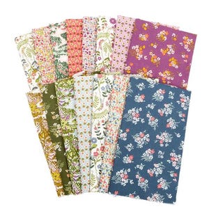 May include: A collection of floral fabric squares in various colors, including purple, blue, green, and pink. The fabrics feature diverse floral patterns, suitable for quilting or crafting projects. The arrangement showcases a variety of designs and hues.
