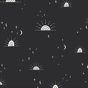 May include: A black fabric featuring a repeating white line-art pattern of suns rising over a horizon line, interspersed with various sizes of crescent moons and five-pointed stars scattered across the dark background in a celestial motif.