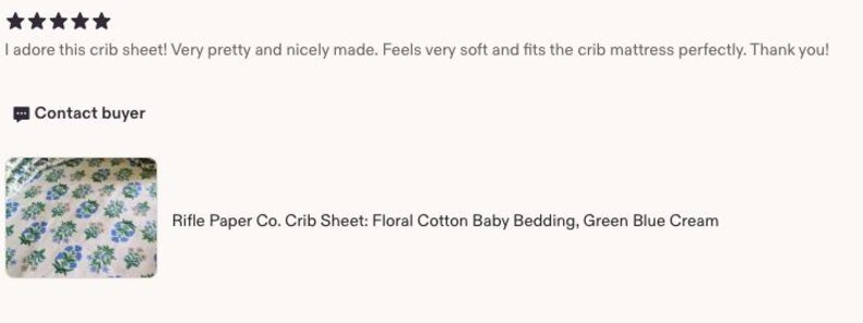 May include: A crib sheet with a floral pattern in green, blue, and cream. The text "Rifle Paper Co. Crib Sheet: Floral Cotton Baby Bedding, Green Blue Cream" is visible.