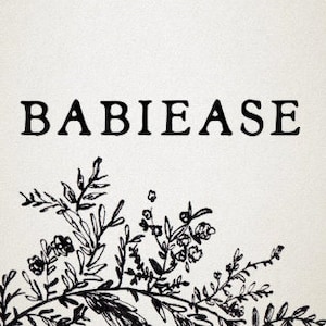 May include: Square, off-white print featuring the word "BABIEASE" in a bold, black serif font. A detailed black floral illustration adorns the bottom, with leaves and delicate blossoms. The design is simple and elegant.