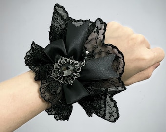 Gothic black lace wrist cuffs with satin bow and gemstone charm – elegant Victorian Lolita bracelet sleeves for cosplay or fashion
