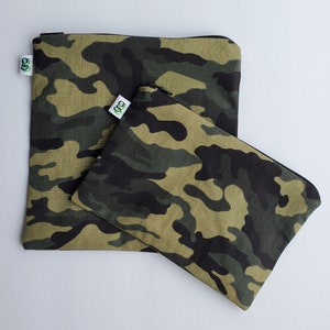 May include: Two camouflage print zippered pouches. The larger pouch is green, black, and tan. The smaller pouch is green, black, and tan. Both pouches have a green and white logo on them.